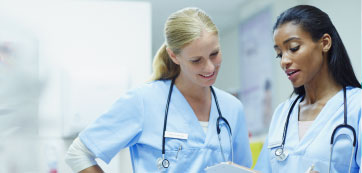 Two nurses looking at a chart - HealthStream
