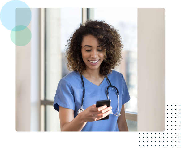 Smiling nurse looking at a cell phone - NurseGrid by HealthStream